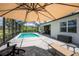 The covered poolside patio offers a perfect blend of comfort and scenic views at 17924 Corkwood Bend Trl, Punta Gorda, FL 33982