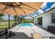 The backyard pool is framed by a scenic landscape with a covered lounge area at 17924 Corkwood Bend Trl, Punta Gorda, FL 33982
