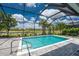 The pool area features a lake view and enclosed screening at 17924 Corkwood Bend Trl, Punta Gorda, FL 33982
