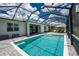 Relaxing screened-in pool, exterior view, with patio and lounge chairs and a view of the back of the house at 17924 Corkwood Bend Trl, Punta Gorda, FL 33982