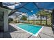 Screened-in pool with blue water, brick patio, and a view of a lake with palm trees in the background at 17924 Corkwood Bend Trl, Punta Gorda, FL 33982