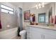 This bathroom is equipped with white cabinetry, granite countertops and a shower/tub combo at 1993 E Isles Rd, Port Charlotte, FL 33953