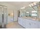 The bathroom offers granite countertops, double sinks, and a glass-enclosed shower at 1993 E Isles Rd, Port Charlotte, FL 33953