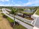 Aerial view of West Port entrance with well-maintained landscaping and pond with fountain at 1993 E Isles Rd, Port Charlotte, FL 33953
