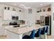 Well-appointed kitchen features stainless appliances, granite countertops, a mosaic backsplash, and a center island at 1993 E Isles Rd, Port Charlotte, FL 33953