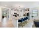 Spacious open-concept kitchen featuring an island with seating, stainless steel appliances, and bright white cabinetry at 1993 E Isles Rd, Port Charlotte, FL 33953