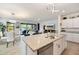 Spacious open-plan kitchen with granite countertops, a center island, and views of the living and dining areas at 1993 E Isles Rd, Port Charlotte, FL 33953