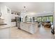 Open-concept kitchen features an island, granite countertops, stainless appliances, and views of the living area at 1993 E Isles Rd, Port Charlotte, FL 33953