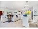 Bright open-concept living space featuring a living room, dining area, and kitchen with modern decor and ample natural light at 1993 E Isles Rd, Port Charlotte, FL 33953