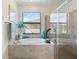 Bright, modern main bathroom featuring a soaking tub with a view, and a glass-enclosed shower at 1993 E Isles Rd, Port Charlotte, FL 33953