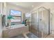 Bright, modern main bathroom featuring a soaking tub with a view, and a glass-enclosed shower at 1993 E Isles Rd, Port Charlotte, FL 33953