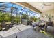 Relaxing screened patio area with hot tub and outdoor dining space for backyard entertaining at 1993 E Isles Rd, Port Charlotte, FL 33953