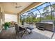 Screened patio with hot tub and dining area, perfect for backyard gatherings at 1993 E Isles Rd, Port Charlotte, FL 33953