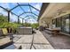 Spacious screened-in patio with dining area, barbecue, and relaxing hot tub at 1993 E Isles Rd, Port Charlotte, FL 33953
