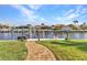 Waterfront backyard with dock, seating, and beautifully manicured lawn at 2100 Via Esplanade, Punta Gorda, FL 33950