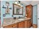 Bathroom boasting granite countertops, wood cabinetry, and decorative accents at 2100 Via Esplanade, Punta Gorda, FL 33950