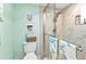 Bathroom featuring a modern shower with glass doors, a toilet, and ocean decor at 2100 Via Esplanade, Punta Gorda, FL 33950