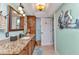 Bathroom featuring granite counters, ample cabinet space, and light blue walls at 2100 Via Esplanade, Punta Gorda, FL 33950