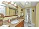 The bathroom offers a granite vanity top, a large mirror, and a shower with a curtain at 2100 Via Esplanade, Punta Gorda, FL 33950
