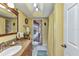 Bathroom features granite vanity top, large mirror, shower, with pool view through the open door at 2100 Via Esplanade, Punta Gorda, FL 33950