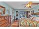 Brightly-decorated bedroom with backyard views, a ceiling fan, and hardwood floors at 2100 Via Esplanade, Punta Gorda, FL 33950