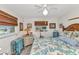 Bright bedroom with coastal decor, ceiling fan, and natural light from two windows at 2100 Via Esplanade, Punta Gorda, FL 33950
