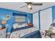 This cozy bedroom features blue walls and beach-themed decor for a cheerful coastal vibe at 2100 Via Esplanade, Punta Gorda, FL 33950