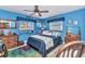 Vibrant blue bedroom featuring marine decorations, a ceiling fan, and lots of character at 2100 Via Esplanade, Punta Gorda, FL 33950