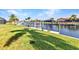 Spacious backyard dock with lush green lawn and waterfront views at 2100 Via Esplanade, Punta Gorda, FL 33950