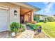 Charming front entrance with colorful landscaping, brick path, and stylish exterior lighting at 2100 Via Esplanade, Punta Gorda, FL 33950
