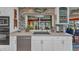 Modern kitchen with stainless steel appliances, light countertops, and pool view at 2100 Via Esplanade, Punta Gorda, FL 33950
