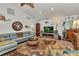 Bright living room featuring large sofa, decorative fireplace, and vaulted ceilings at 2100 Via Esplanade, Punta Gorda, FL 33950