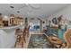 Stylish living room featuring a bar, rattan chairs, and access to an outdoor pool area at 2100 Via Esplanade, Punta Gorda, FL 33950