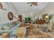 Bright living room featuring large sofa, area rug, decorative fireplace, and vaulted ceilings at 2100 Via Esplanade, Punta Gorda, FL 33950