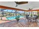 The screened patio features an outdoor dining area with a beautiful pool at 2100 Via Esplanade, Punta Gorda, FL 33950