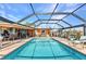 Screened-in pool provides ample space for outdoor relaxation and entertaining along the waterfront at 2100 Via Esplanade, Punta Gorda, FL 33950