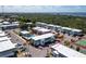 Drone shot showcasing a beautiful condominium complex with a swimming pool, tennis court, and surrounding landscape at 22375 Edgewater Dr # 123, Punta Gorda, FL 33980