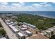 Scenic aerial view of a condo complex next to a tennis court in a lush, tropical location at 22375 Edgewater Dr # 123, Punta Gorda, FL 33980