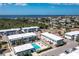 Breathtaking aerial view featuring the condominium complex, pool, tennis court, and the surrounding neighborhood at 22375 Edgewater Dr # 123, Punta Gorda, FL 33980