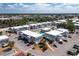 An aerial view of gray condo buildings, a swimming pool, green spaces and a parking lot under a blue sky with wispy clouds at 22375 Edgewater Dr # 123, Punta Gorda, FL 33980