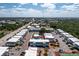 Bird's-eye view of the condo complex, highlighting the pool, tennis court, and surrounding community at 22375 Edgewater Dr # 123, Punta Gorda, FL 33980