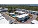 An aerial view of condo building circled in red, swimming pool, parking lot and landscaping under blue skies with scattered clouds at 22375 Edgewater Dr # 123, Punta Gorda, FL 33980