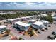 Overhead view of gray condo buildings, circled in red, with pool and parking under a blue sky with clouds in a sunny outdoor setting at 22375 Edgewater Dr # 123, Punta Gorda, FL 33980