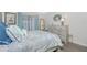 Well-lit bedroom featuring a dresser, wall decor, and comfortable bedding at 22375 Edgewater Dr # 123, Punta Gorda, FL 33980