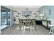 Coastal dining area featuring wooden table, decor shelves, and a view to the outdoor patio at 22375 Edgewater Dr # 123, Punta Gorda, FL 33980