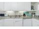 Well-lit kitchen boasts white cabinetry, granite countertops, and stainless-steel appliances at 22375 Edgewater Dr # 123, Punta Gorda, FL 33980