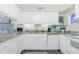 Bright kitchen featuring white cabinetry, granite counters, and modern appliances for easy cooking at 22375 Edgewater Dr # 123, Punta Gorda, FL 33980