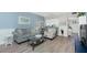Cozy living room with a comfortable sofa, patterned armchair, and view of the kitchen at 22375 Edgewater Dr # 123, Punta Gorda, FL 33980