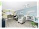 Cozy living room featuring stylish seating, a ceiling fan, and beach-themed decor, creating a comfortable and inviting space at 22375 Edgewater Dr # 123, Punta Gorda, FL 33980