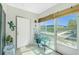 Bright sunroom featuring tile floors, large windows with privacy shades, and access to the outdoors at 22375 Edgewater Dr # 123, Punta Gorda, FL 33980